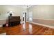 Cozy living area featuring hardwood floors, a piano, and natural light from the window at 420 S Cedar St, Lincolnton, NC 28092