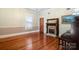 Bright living room with hardwood floors, decorative fireplace, and large windows at 420 S Cedar St, Lincolnton, NC 28092