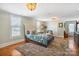 Bright main bedroom featuring wood floors, neutral walls, and a decorative chandelier at 420 S Cedar St, Lincolnton, NC 28092