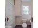 Functional bathroom featuring a toilet, small vanity and cabinet for storage at 435 W Whitley St, Norwood, NC 28128