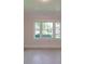 Bedroom featuring neutral carpet and natural light from three windows overlooking a neighborhood at 435 W Whitley St, Norwood, NC 28128