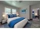 Tastefully decorated bedroom with hardwood-look flooring and bright blue accents at 435 W Whitley St, Norwood, NC 28128