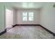 Bright, empty bedroom with neutral walls and floors, with a door and large window at 435 W Whitley St, Norwood, NC 28128