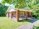 Classic brick home with a wraparound porch, offering outdoor living space and curb appeal at 435 W Whitley St, Norwood, NC 28128