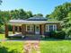 Charming brick home with a covered front porch, well-maintained lawn, and a welcoming entrance at 435 W Whitley St, Norwood, NC 28128
