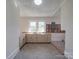 Neutral kitchen with rustic wood accent wall and natural light at 435 W Whitley St, Norwood, NC 28128