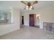 Living room with rustic wall detail and access to a bathroom, bedroom, and kitchen at 435 W Whitley St, Norwood, NC 28128