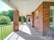 Covered porch with brick columns, providing a shaded and inviting outdoor space at 435 W Whitley St, Norwood, NC 28128