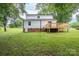 Exterior back view of the home, showing the deck and large backyard, great for outdoor entertaining at 4633 Old Mill Rd, Gastonia, NC 28056
