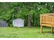 Backyard view showcasing outbuilding, trees and deck offering privacy and space for outdoor activities at 4633 Old Mill Rd, Gastonia, NC 28056