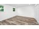 Bright bedroom with hardwood floors, white walls, and two windows offering plenty of natural light at 4633 Old Mill Rd, Gastonia, NC 28056