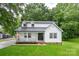 Charming renovated two-story home featuring a welcoming front porch, fresh landscaping, and white board and batten siding at 4633 Old Mill Rd, Gastonia, NC 28056