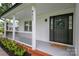 Close-up of the welcoming front porch area showcases the house number, black front door, and manicured landscaping at 4633 Old Mill Rd, Gastonia, NC 28056