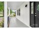 Inviting covered front porch with white columns and black front door, perfect for relaxing at 4633 Old Mill Rd, Gastonia, NC 28056