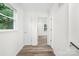 Bright hallway showcasing hardwood floors, doors, and natural light streaming through the windows at 4633 Old Mill Rd, Gastonia, NC 28056