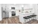 Modern, all-white kitchen featuring stainless steel appliances, shaker cabinets, subway tile backsplash, and breakfast bar at 4633 Old Mill Rd, Gastonia, NC 28056
