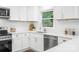 Bright kitchen features white cabinets, stainless steel appliances, granite countertops, and a window with backyard views at 4633 Old Mill Rd, Gastonia, NC 28056