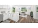 Open kitchen featuring white cabinetry, stainless appliances, breakfast bar, and adjacent dining area with ample natural light at 4633 Old Mill Rd, Gastonia, NC 28056