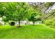 Lush green backyard featuring well-maintained lawn, trees, and outdoor patio area at 539 Turquoise Way, Fort Mill, SC 29708