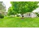 Expansive backyard with mature trees, green lawn, and the side of the home at 539 Turquoise Way, Fort Mill, SC 29708