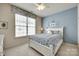 Light-filled bedroom with blue walls, white furniture, and carpet flooring at 539 Turquoise Way, Fort Mill, SC 29708