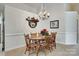 Formal dining room with tile flooring, wainscoting, and an elegant chandelier at 539 Turquoise Way, Fort Mill, SC 29708
