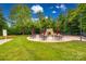 Outdoor fire pit with seating area and red umbrellas for a cozy gathering space at 539 Turquoise Way, Fort Mill, SC 29708
