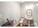 Elegant powder room with pedestal sink, decorative mirror, and warm lighting at 5424 Morris Hunt Dr, Fort Mill, SC 29708