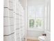 Bright bathroom with a decorative shower curtain and a large window with shutter at 5424 Morris Hunt Dr, Fort Mill, SC 29708