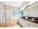 Bright bathroom with a glass enclosed shower, soaking tub, double sinks, and white cabinets at 5424 Morris Hunt Dr, Fort Mill, SC 29708