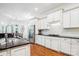 This spacious kitchen is equipped with stainless steel appliances, granite counters, custom cabinets, and hardwood floors at 5424 Morris Hunt Dr, Fort Mill, SC 29708