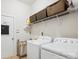 Well-lit laundry room featuring a modern washer, dryer, and ample shelving space for storage at 5424 Morris Hunt Dr, Fort Mill, SC 29708