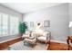 Cozy sitting room with hardwood floors and plantation shutters providing natural light at 5424 Morris Hunt Dr, Fort Mill, SC 29708