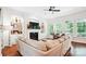 Bright and airy living room featuring a fireplace, built-in shelving, and hardwood floors at 5424 Morris Hunt Dr, Fort Mill, SC 29708
