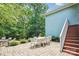 Outdoor patio with a dining table, seating area, and stairs leading up to the house at 5424 Morris Hunt Dr, Fort Mill, SC 29708