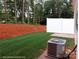 Spacious back yard with newly laid sod, white vinyl fence, and HVAC system shown at 6712 W Sugar Creek Rd, Charlotte, NC 28269