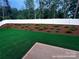 Beautifully landscaped back yard featuring lush greenery and a white fence for added privacy at 6712 W Sugar Creek Rd, Charlotte, NC 28269