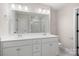 Elegant bathroom with dual sinks, modern vanity, and glass-enclosed shower, offering a spa-like experience at 6712 W Sugar Creek Rd, Charlotte, NC 28269
