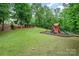 Expansive backyard featuring a play set and lush greenery at 6873 Pine Moss Ln, Clover, SC 29710