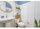 Elegant powder room featuring a stylish pedestal sink, decorative shelving, and serene blue accents at 6873 Pine Moss Ln, Clover, SC 29710