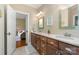 Double sink bathroom with wooden cabinets and view to another bedroom at 6873 Pine Moss Ln, Clover, SC 29710