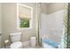 Cozy bathroom featuring toilet, tub and window for natural light at 6873 Pine Moss Ln, Clover, SC 29710