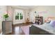 Bright bedroom with natural light, hardwood floors, gray dresser, and bed at 6873 Pine Moss Ln, Clover, SC 29710