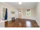 Bright, open bedroom featuring hardwood floors, a USA map, and a view into a bathroom at 6873 Pine Moss Ln, Clover, SC 29710