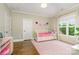 Bright bedroom with hardwood floors, a pink rug, and a cozy daybed at 6873 Pine Moss Ln, Clover, SC 29710