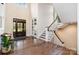 Elegant foyer with hardwood floors, staircase, and a view of the front door at 6873 Pine Moss Ln, Clover, SC 29710