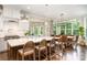 Bright, open kitchen featuring an oversized island with seating and an adjacent eat-in dining area with beautiful outdoor views at 6873 Pine Moss Ln, Clover, SC 29710