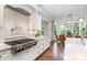 Close up view of a kitchen with stainless steel appliances and fixtures, bright white cabinets, and view to the dining area at 6873 Pine Moss Ln, Clover, SC 29710