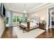 Serene main bedroom with neutral tones, a tufted headboard, and views of the outdoors at 6873 Pine Moss Ln, Clover, SC 29710