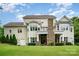 Spacious home with a stone chimney, rear balconies, and a well-manicured lawn at 6873 Pine Moss Ln, Clover, SC 29710